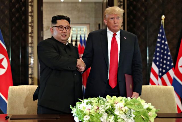 U.S. President Donald Trump shakes hands with North Korea's leader Kim Jong after signed documents, after their summit in Singapore