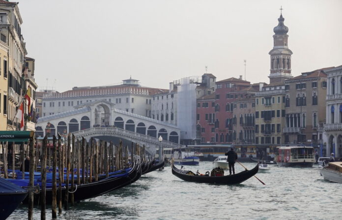 A gondola is pictured on Grand Canal in front of Rialto bridge in Venice