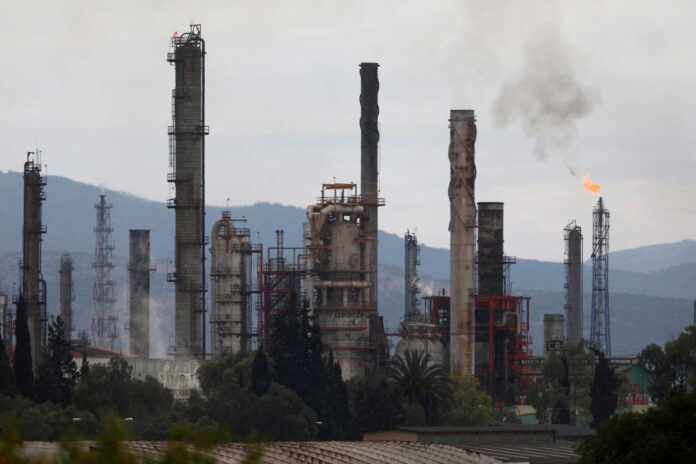 FILE PHOTO: Excess natural gas is burnt, or flared, from Mexican state-owned Pemex's Tula oil refinery, located adjacent to the Tula power plant belonging to national power company Comision Federal de Electricidad, or CFE, in Tula de Allende
