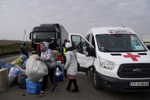 Aid workers prepare a shipment of humanitarian supplies to deliver into Ukraine, in Medyka